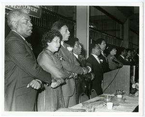Dr. Joseph Echols Lowery, Evelyn Gibson Lowery and others lock arms and sing, "We Shall Overcome" at the Drum Major Awards dinner
